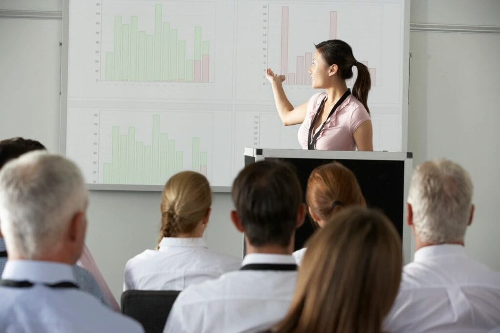 A woman is giving a presentation to an audience.