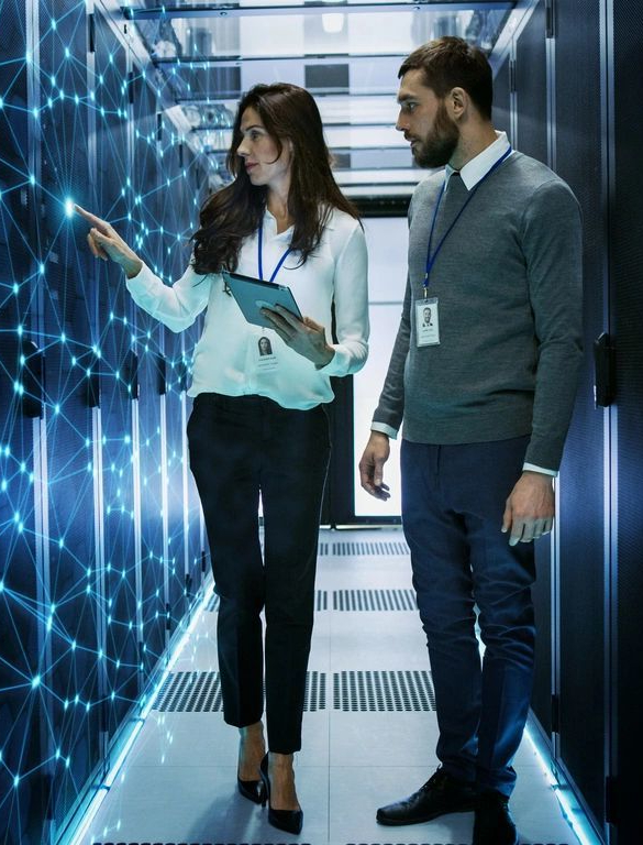 A man and woman in business attire are standing next to each other.