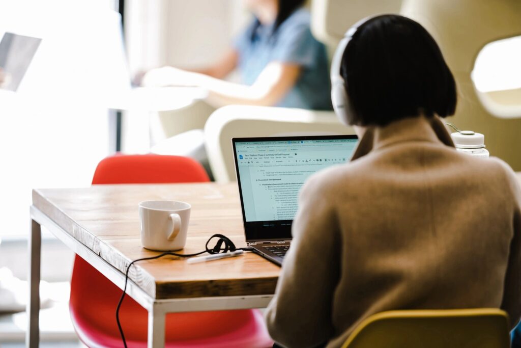 A person sitting at a table with a laptop.